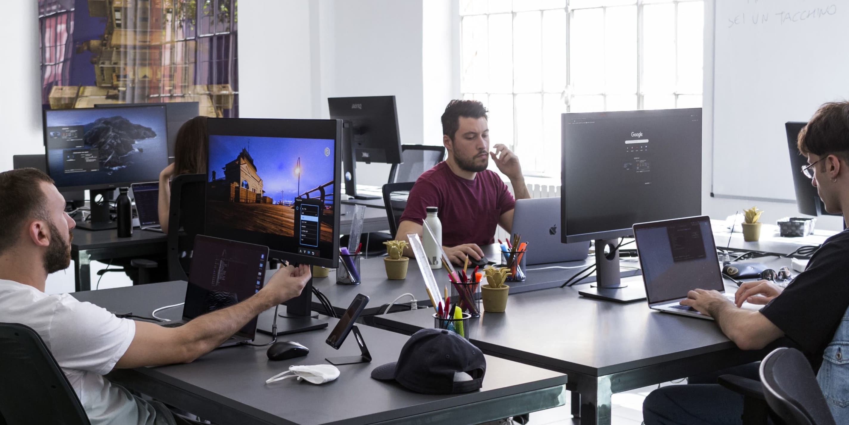 Designers working at their station inside Notomia's openspace