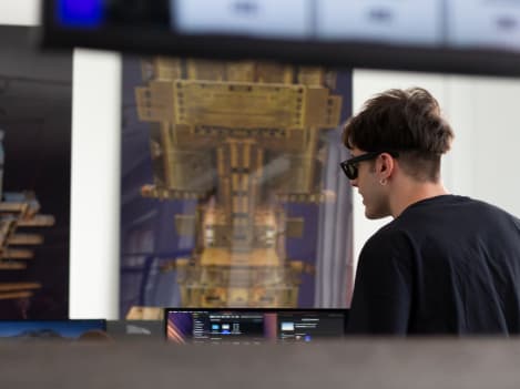 A person working in front of a monitor inside Notomia's office